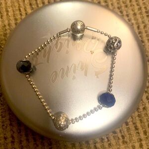 Pandora Essence Bracelet w/ four charms plus silver Pandora clasp.